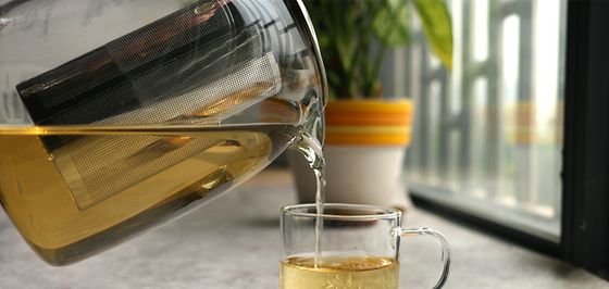 Big Teapot Pouring In Glass Cup