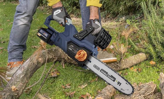 Battery Chainsaw Cutting Log On Lawn