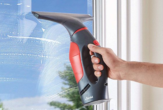 Window Cleaner Vacuum In Red And Black On Glass