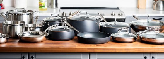 Steel Induction Cookware On Kitchen Counter