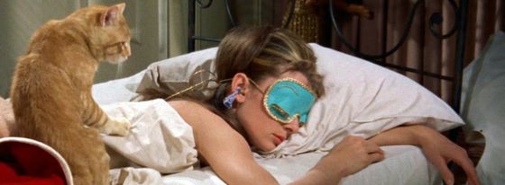 Ginger Cat Waking Woman Wearing Blue Sleep Mask