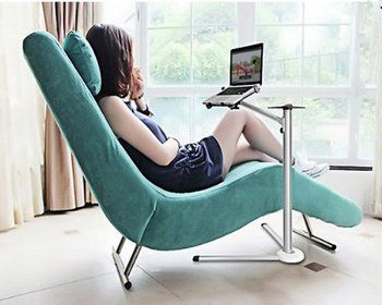 Woman Sitting On Chair Using Handy Stand Laptop