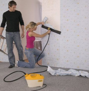Professional Wallpaper Steamer Used By Woman