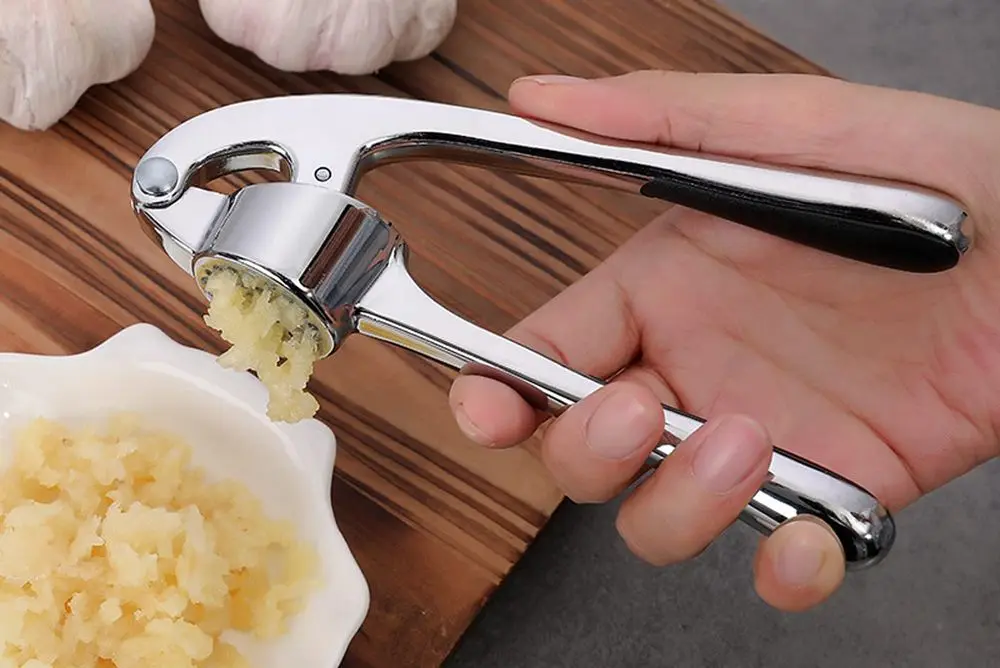 Steel Garlic Press And Man's Hand
