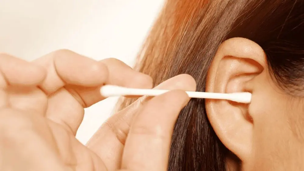 Woman With Cotton Bud In Ear