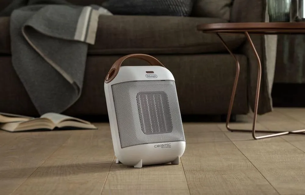 DeLonghi Capsule 1800 Watts Fan Heater On Wooden Floor
