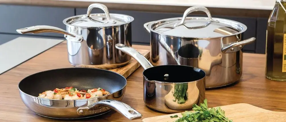 Stainless Steel Pots And Pans On Wood Shelf