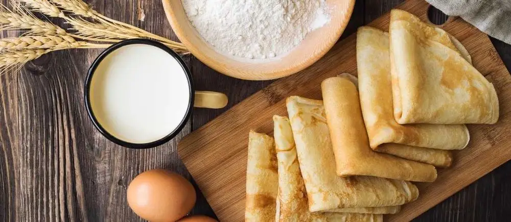 Folded Crêpes On Plate With Eggs