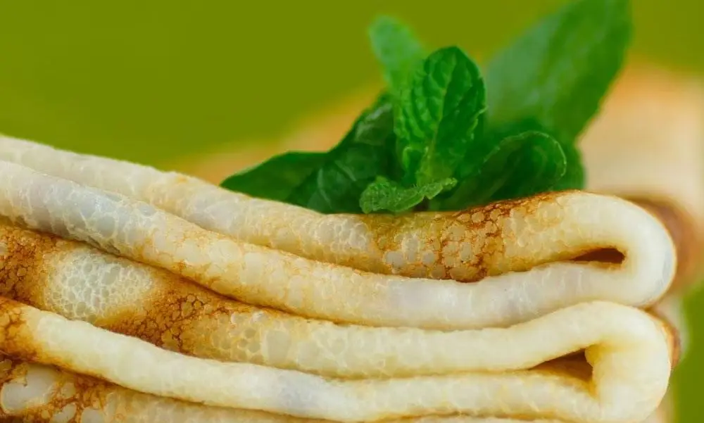 Tastiest Crêpes On Chopping Board With Leaves