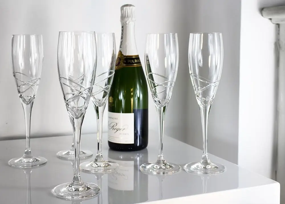 5 Etched Champagne Glasses On White Table